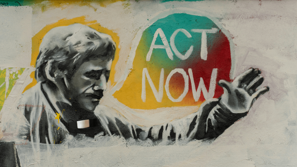 A clergy man with the words 'act now' in a bubble to the right